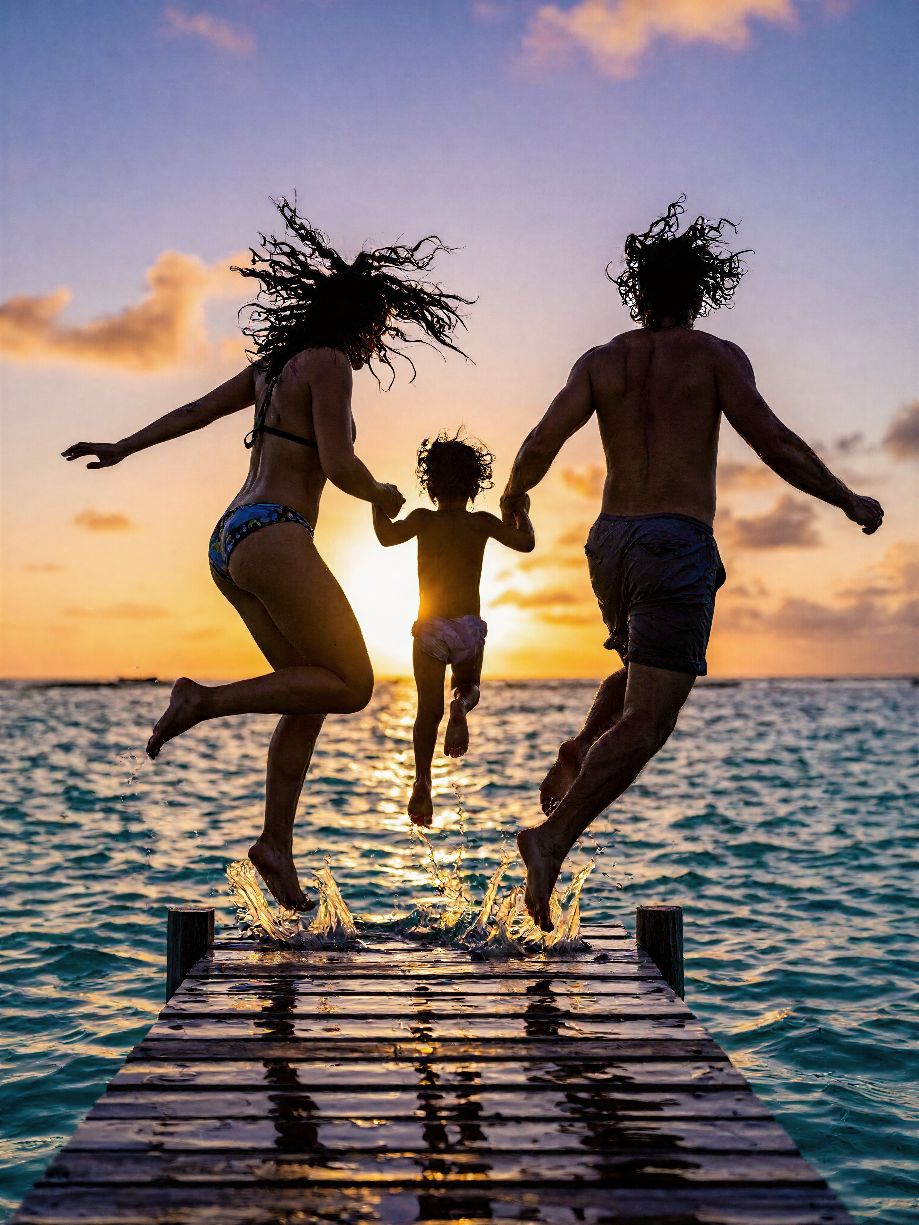 Family Silhouetted at Tropical Sunset — AI generated image